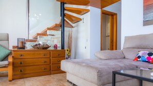 A modern living room with a sofa, wooden dresser, and a glass coffee table. - Near the Beach and with Terrace - Can Bennasar (Can Picafort)