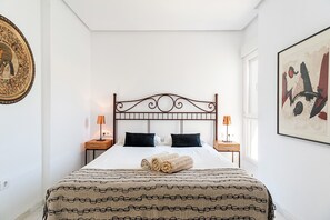 A neatly arranged bedroom with a bed, two bedside tables, and a window. - Exclusive villa with garden and pool - Villa con encanto (Roche)