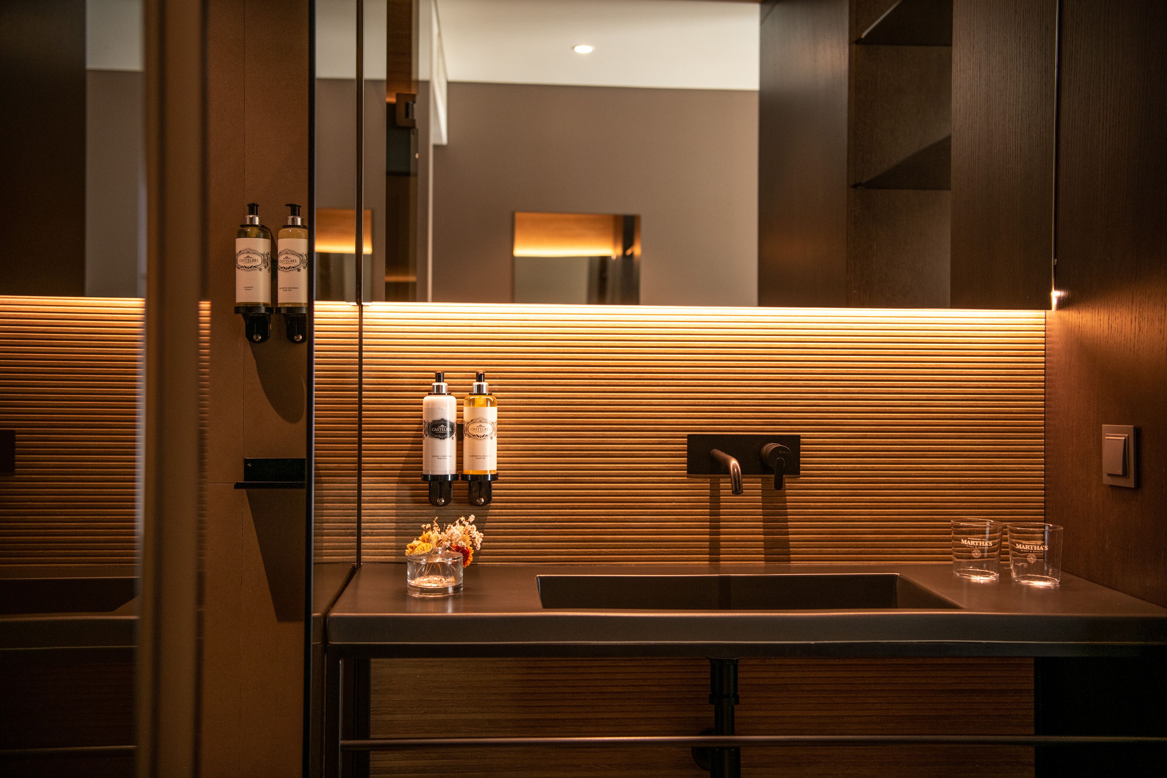 designer toiletries, hair dryer, bathrobes, slippers