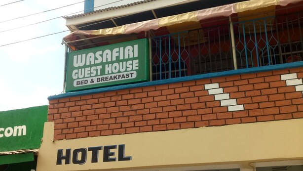A hotel with a sign indicating a guest house and breakfast services. - Wasafiri Guest House (Nakuru)