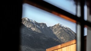 A mountain landscape through a window with wooden framing. - Cosy Strickerhof Apartment 2 with Mountain View & Balcony (St. Leonhard in Passeier)