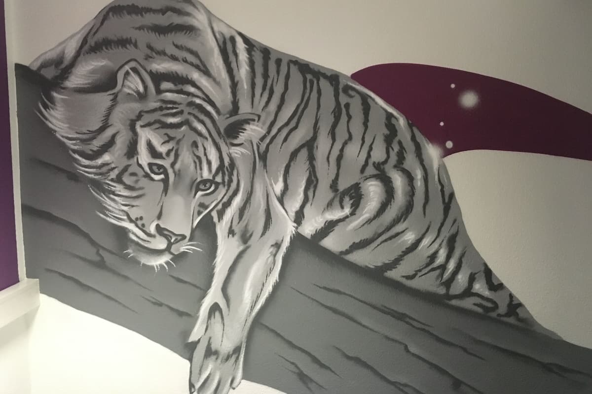 A tiger mural on a wall.