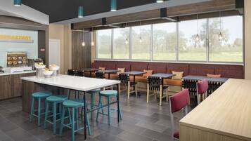A modern breakfast area with a bar, seating, and a view of the outdoors.