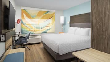 Habitación de hotel moderna con una cama grande, un escritorio, una silla, un televisor de pantalla plana, un cuadro abstracto de gran tamaño, una lámpara y una ventana con vistas.