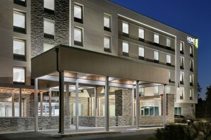 A modern hotel with a covered entrance, multiple floors, and a sign indicating it is a Home2 hotel. - Home2 Suites by Hilton Norfolk Airport (Norfolk)