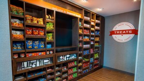 A snack display area with various packaged snacks and a sign reading "Welcome to Imperial Beach". - Hampton Inn & Suites Imperial Beach San Diego (Imperial Beach)