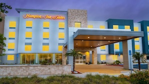 A Hampton Inn & Suites hotel with a modern facade, large windows, and a covered entrance area. - Hampton Inn & Suites Imperial Beach San Diego (Imperial Beach)