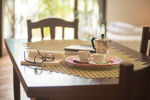 A table with a coffee pot, cups, and a book, suggesting a reading or coffee break setting. - Experience Italian flair up close - Monolocale 900 (Racale)