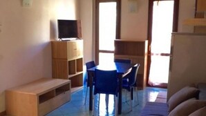 A room with a dining table, chairs, a bench, a television, and a sofa. - N186 - Numana, new two-room apartment with swimming pool (Maratta)