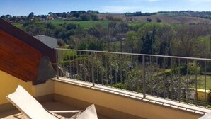 A balcony with a view of a rural landscape, a chair, and a railing. - N186 - Numana, new two-room apartment with swimming pool (Maratta)