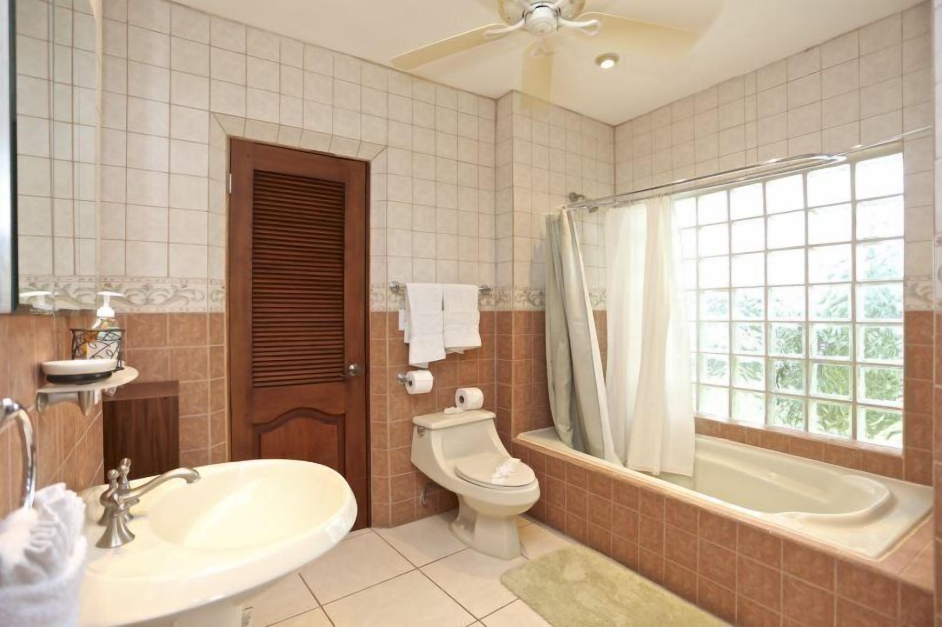 A bathroom with a sink, toilet, and bathtub.