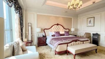 Une chambre à coucher luxueuse, dotée d’un grand lit, d’une chaise longue, d’une table de chevet et d’un lustre.