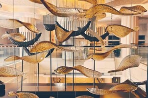 Un interior moderno con elementos decorativos colgantes y una superficie reflectante.
