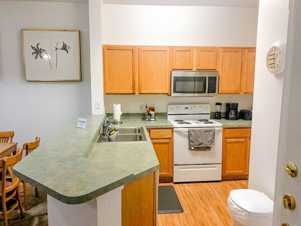 Microwave, dishwasher, coffee/tea maker, cookware/dishes/utensils