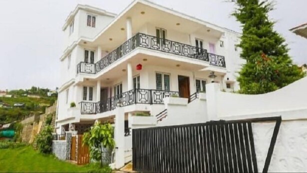 A two-story house with a balcony, a gated entrance, and a small garden area. - Wonder Hill Residency (Ootacamund)