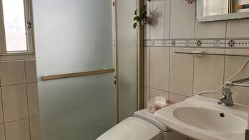 Economy Double Room, Private Bathroom | Bathroom | Shower, free toiletries, hair dryer, slippers