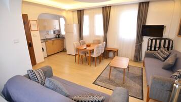 Deluxe Apartment | Living area | 32-inch LCD TV with satellite channels