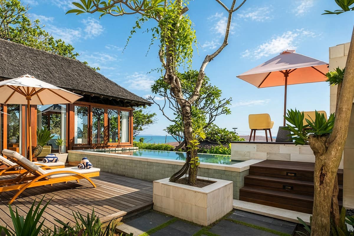 A wooden deck with lounge chairs, a pool, and a thatched-roof structure.