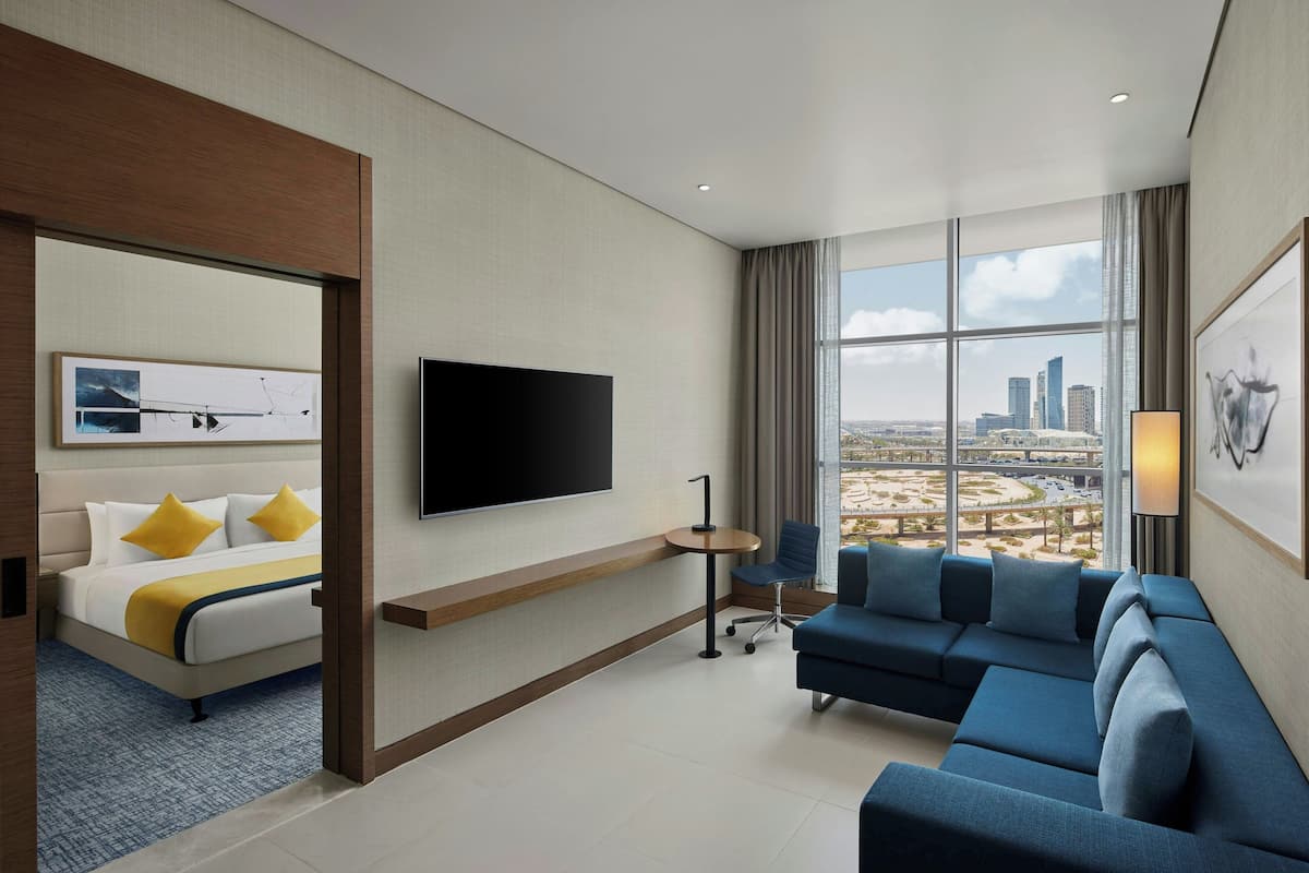 Business Suite, 1 Bedroom, City View | Living area | 55-inch flat-screen TV with satellite channels, TV, pay movies