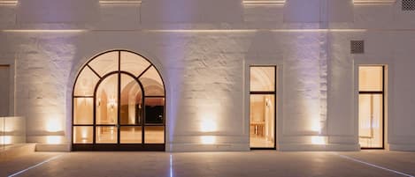 A building facade with a large arched entrance and multiple windows.