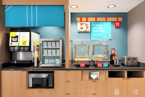 A breakfast bar with a coffee machine, a vending machine, and a toaster.