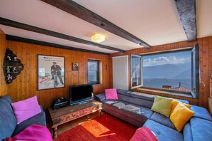 Family Apartment, Multiple Bedrooms, 2 Bathrooms (Chalet Cademario) | Living area | 21-inch TV with satellite channels, fireplace, DVD player