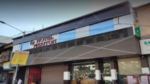 A hotel with a sign reading "HOTEL MERITON" and a partially visible sign for "SA" next to it. - Hotel Meriton (Mumbai)