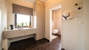 A modern bathroom with a toilet, a sink, and a window with a view.