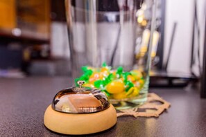 A clear glass container with a lid on a table.