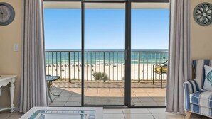 A room with a sliding glass door leading to a balcony with a beach view. - The Summit 506 (Panama City Beach)