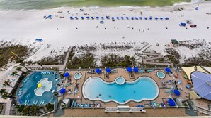 A resort with a large swimming pool, a beach area with sun loungers, and a separate pool area with a lifeguard stand. - 16th-Floor Gulf-Front Condo at Boardwalk – Balcony Views, Resort Pool & Hot Tubs (Panama City Beach)