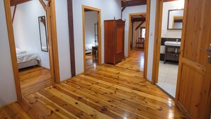 A spacious room with wooden flooring, a bed, a wardrobe, and a bathroom with a sink and mirror. - Family-friendly holiday home with a large playroom and garden. Pet-friendly! (Janowice Wielkie)