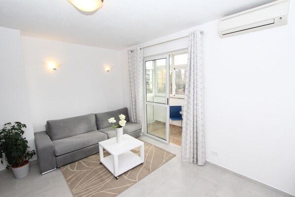 Apartment, 2 Bedrooms | Living area | 1-inch flat-screen TV with satellite channels, TV