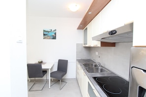 Departamento, 2 habitaciones | Cocina privada | Refrigerador, horno, parrilla de estufa y cafetera y tetera 
