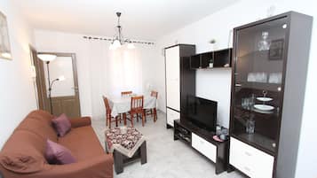 Apartment, 1 Bedroom | Living room | 1-inch flat-screen TV with satellite channels, TV