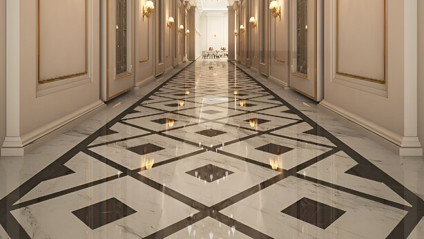A long, elegant hallway with a geometric marble floor, ornate wall sconces, and a large chandelier.