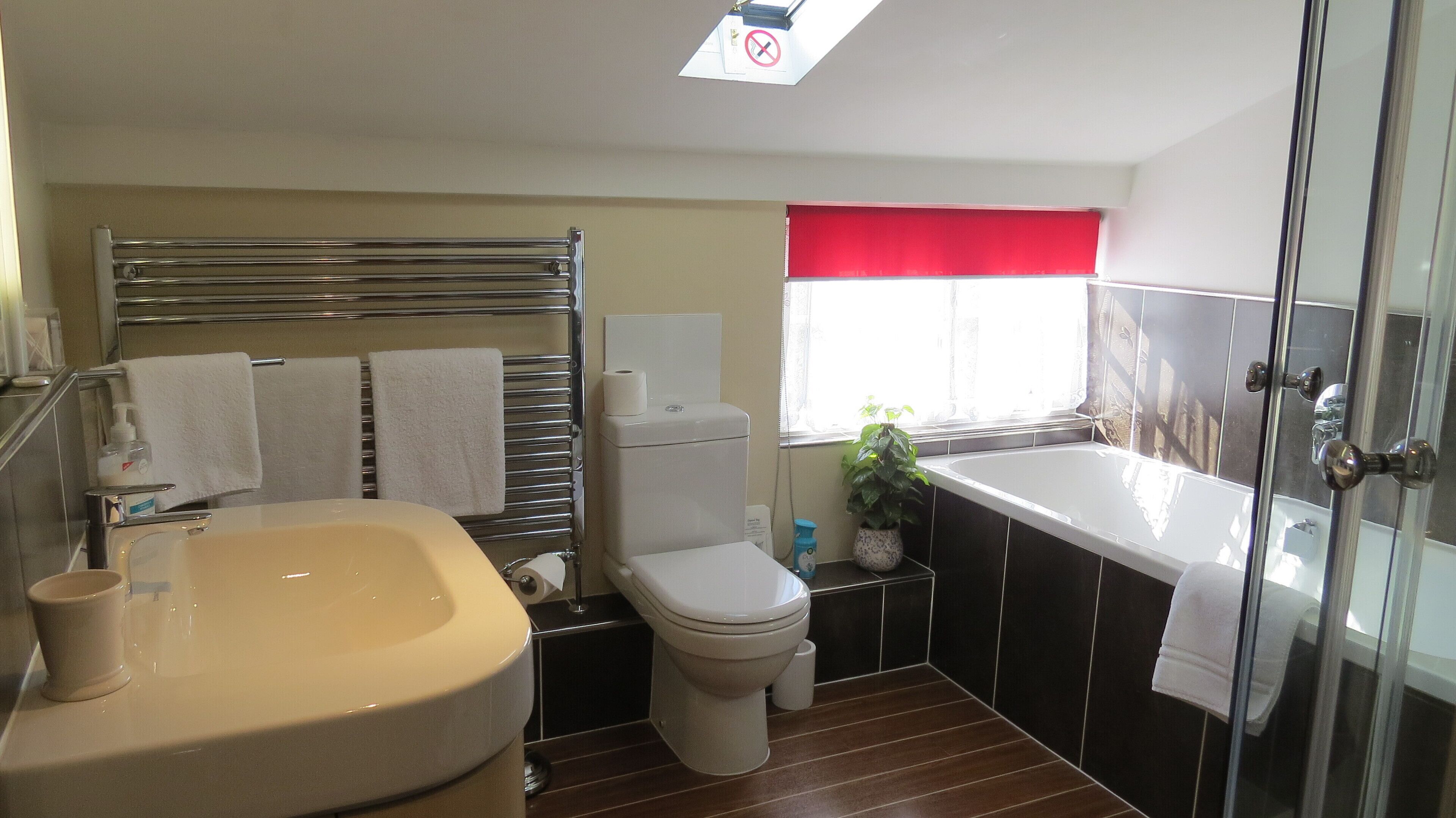 A bathroom with a bathtub, toilet, and sink.
