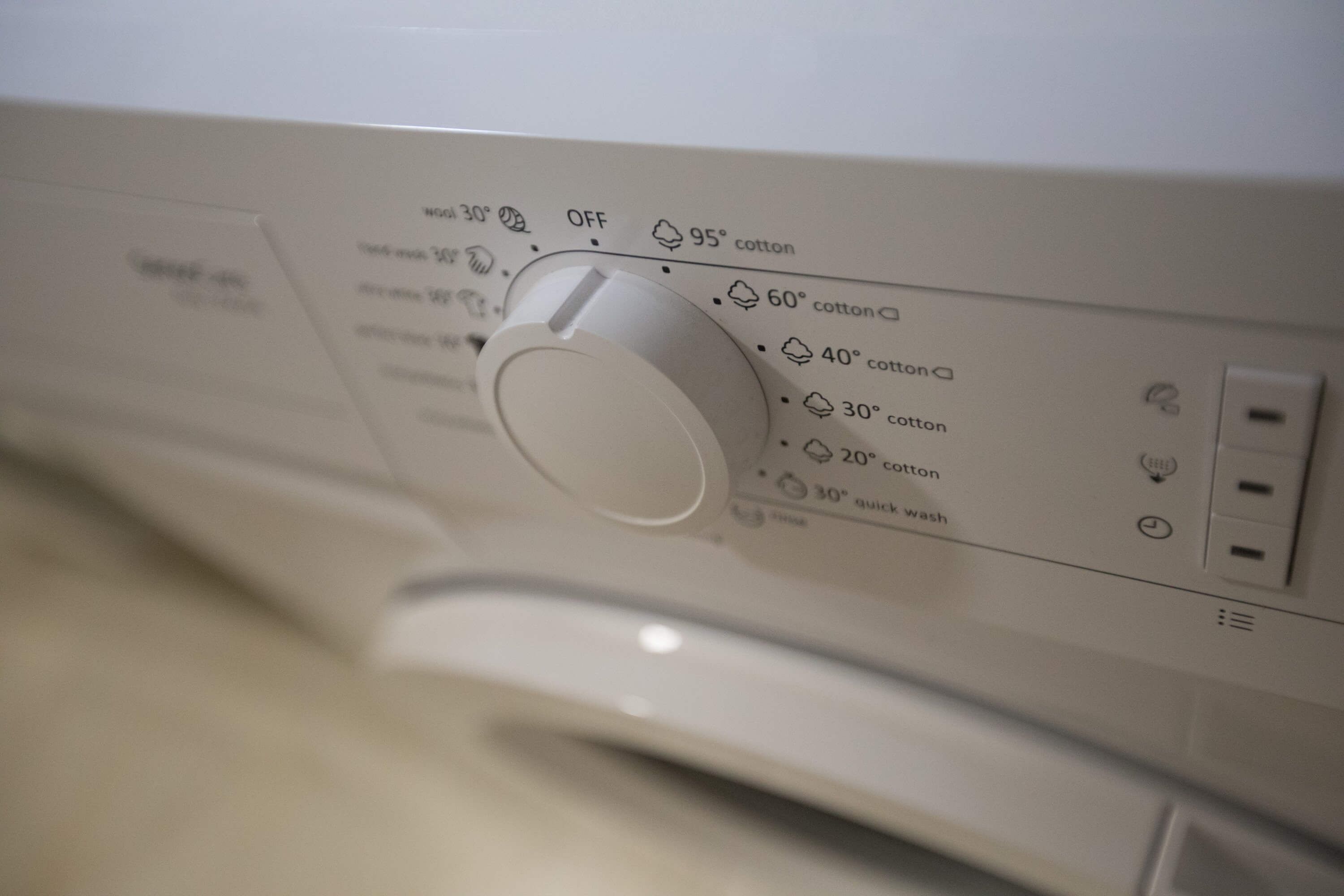 A washing machine with temperature settings and a power button.