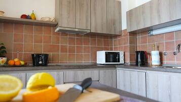 Standard Apartment, 3 Bedrooms, Balcony, Sea View | Private kitchen | Full-sized fridge, microwave, oven, stovetop