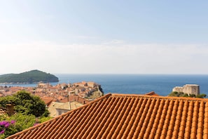 A coastal town with terracotta rooftops, historic buildings, and a view of the sea. - Anika Apartment (Dubrovnik)