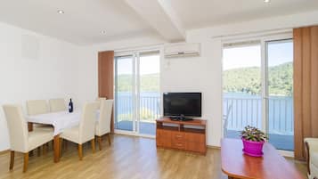 Standard Apartment, 2 Bedrooms, Balcony, Sea View | Living area | Flat-screen TV