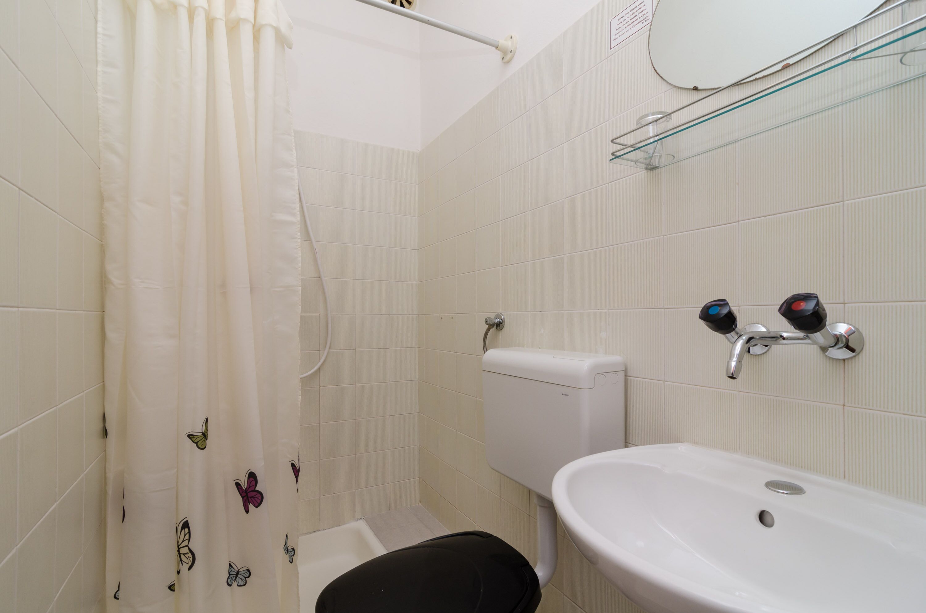 Ein Badezimmer mit Toilette, Waschbecken und Duschvorhang.