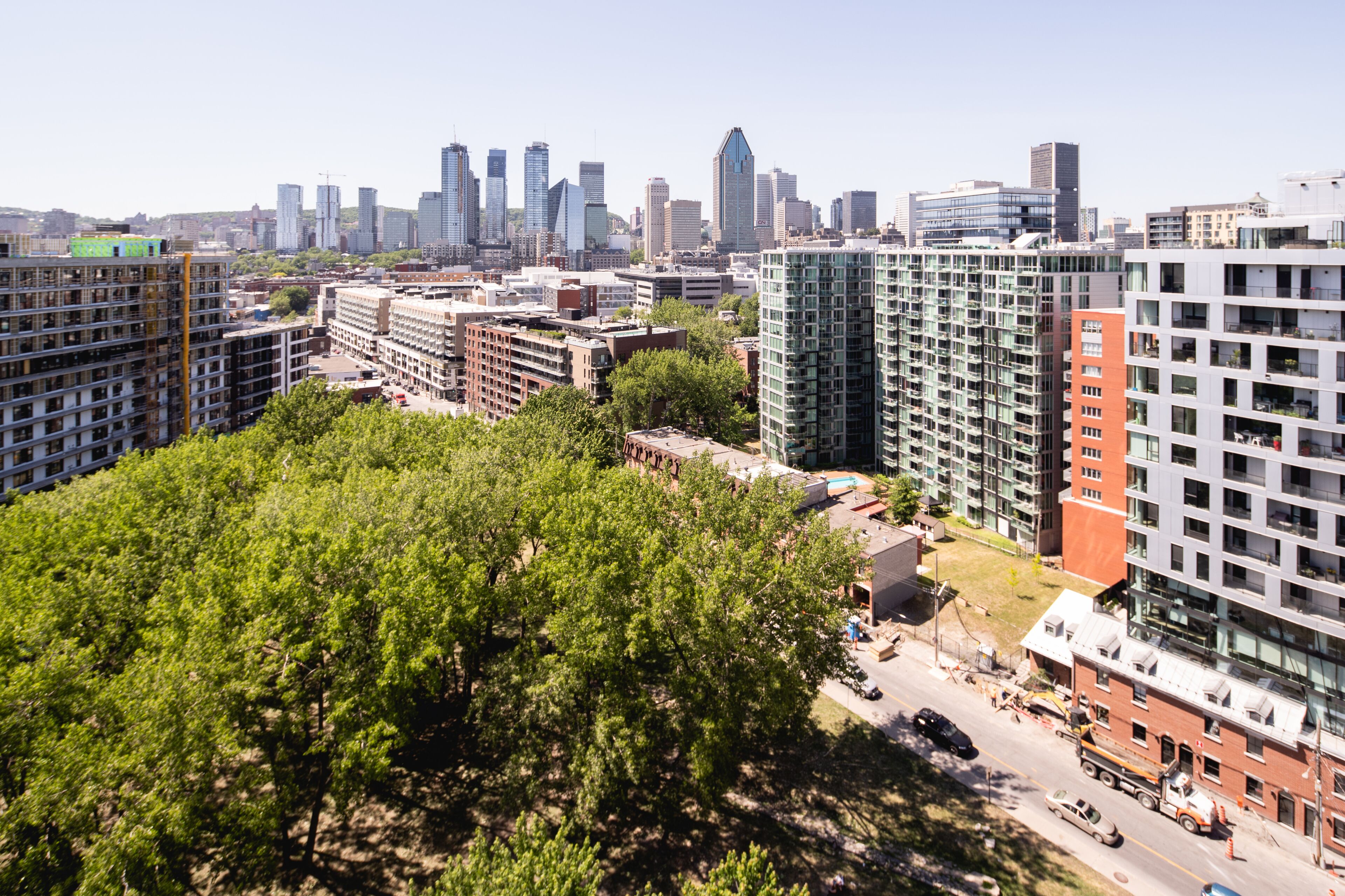 A high-rise building with multiple floors, surrounded by other buildings and greenery.