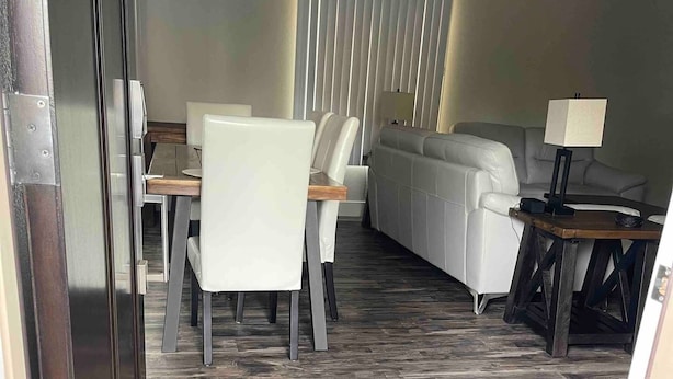 A modern interior with a dining area, a sofa, and a lamp. -  NEAR UO, NEW RENO, SLPS 8, PET STAYS FREE, DECK/GRILL, FENCED YARD, VERY CLEAN
 (Eugene)