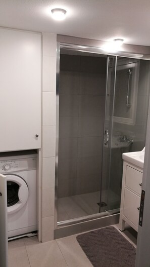 Bathtub, hair dryer, towels, toilet paper