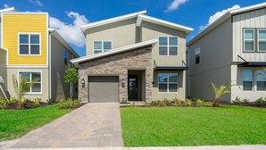 A modern residential building with a stone facade, a garage, and a well-maintained lawn. - (AG2770) Storey Lake VILLA 5/5, Private Pool & Free Waterpark (Kissimmee)