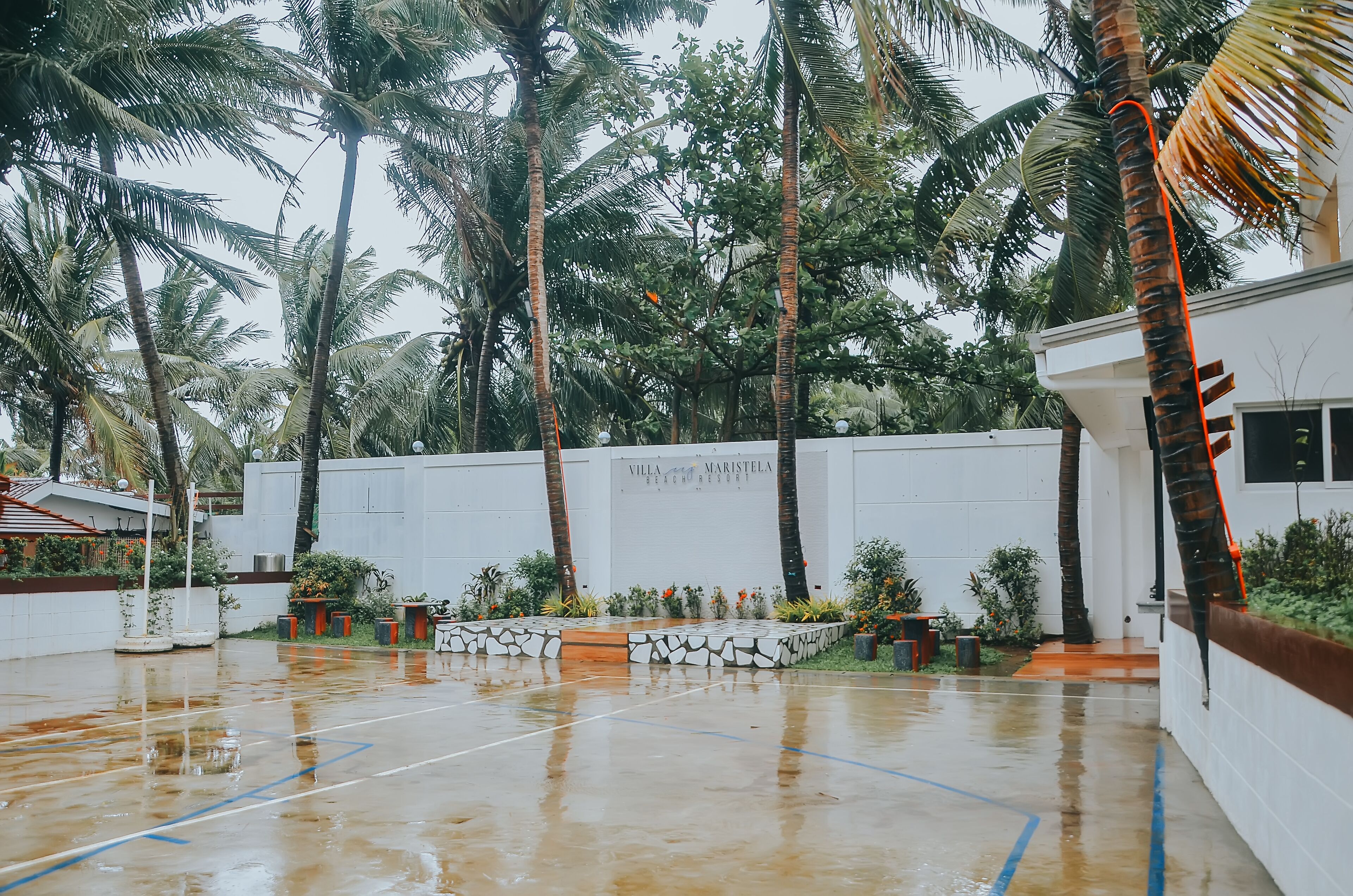 A wet outdoor area with a white building labeled "Villa Maristela Beach Resort."