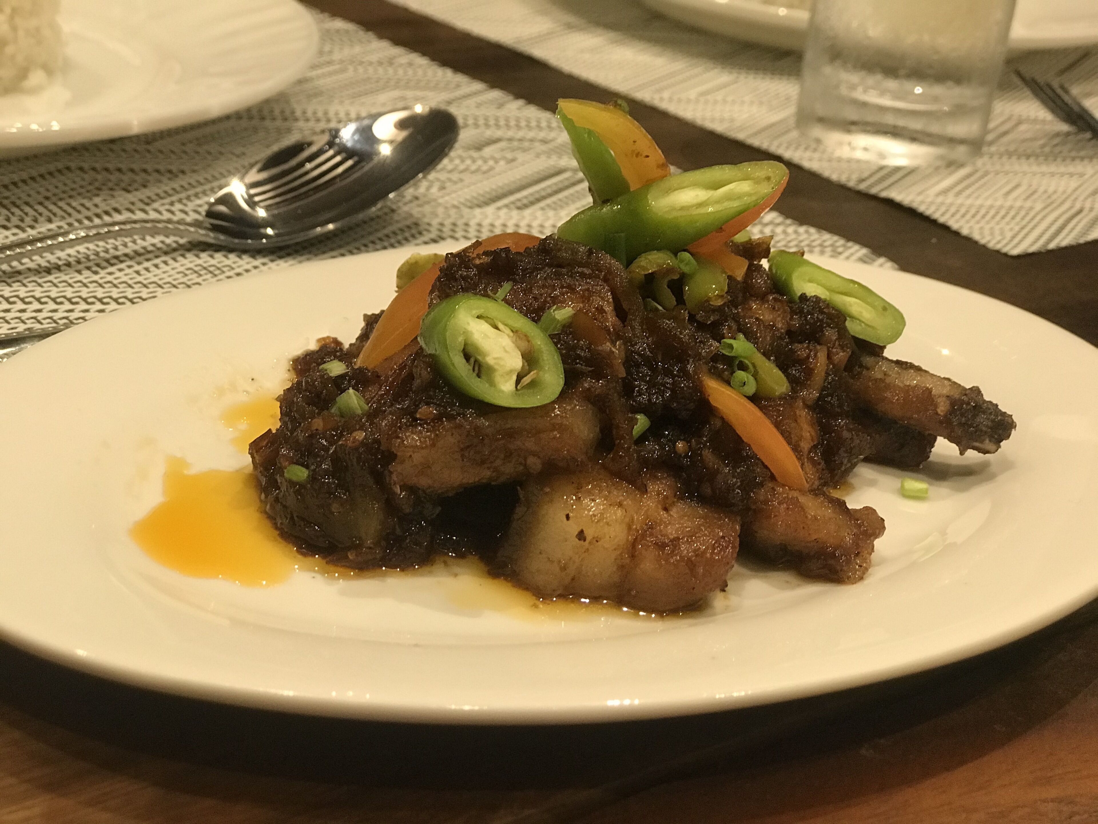 A plate of food with meat and vegetables on a white plate.