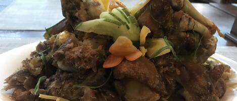 A plate of food with various ingredients, including meat, vegetables, and noodles.