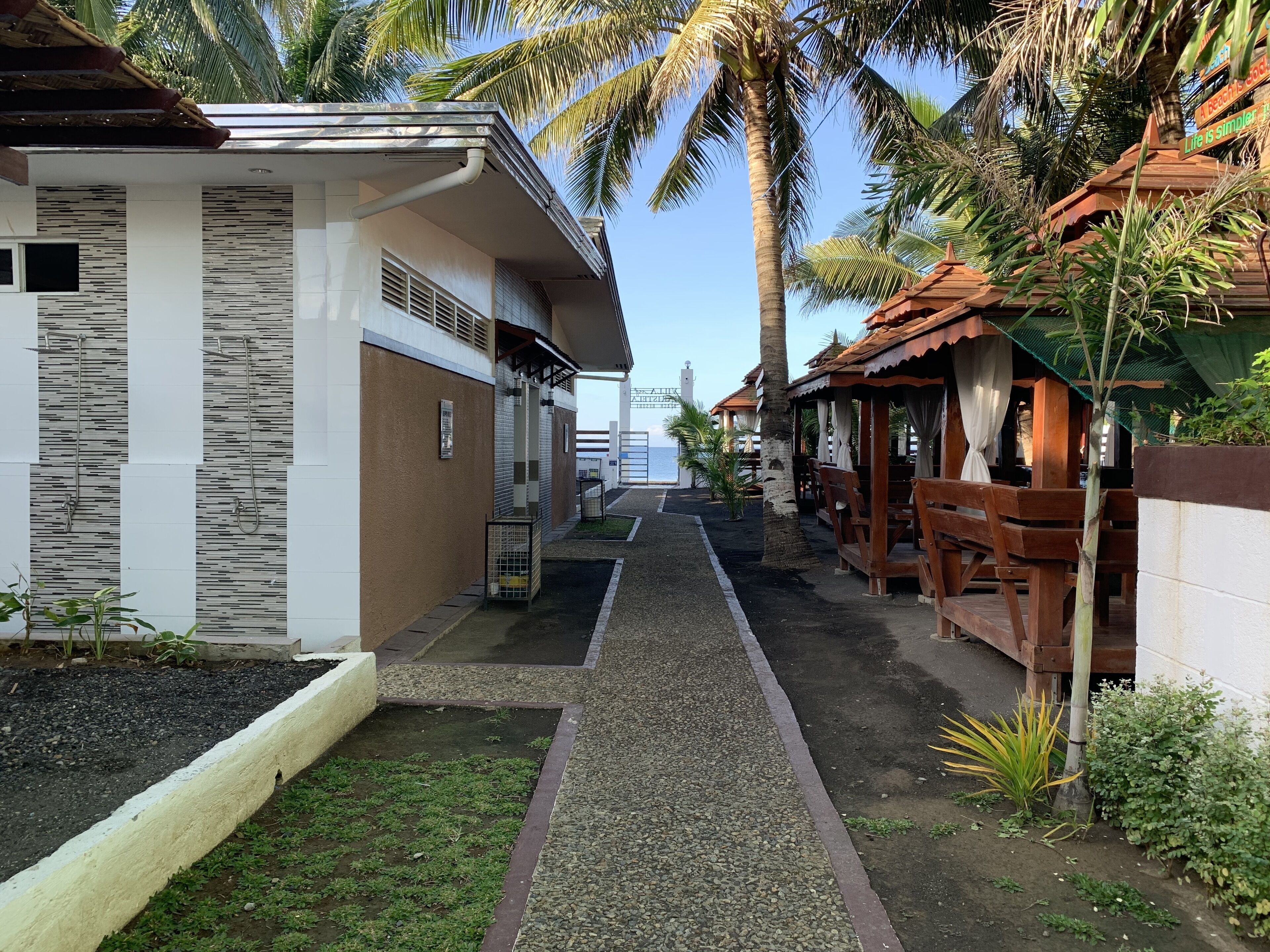 On the beach, black sand, free beach cabanas, sun loungers